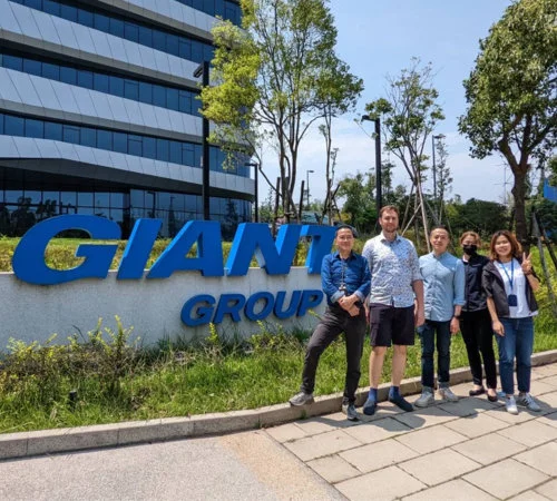 The Mosa team with colleagues beside the Giant Group sign.